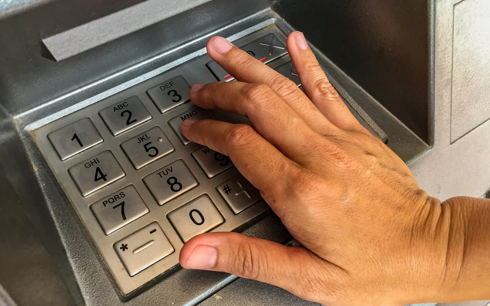 close-up-hand-pressing-number-key-atm-machine